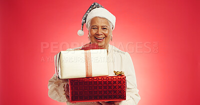 Buy stock photo Christmas, senior woman or gift in studio with portrait, happy or giveaway box in retirement. Elderly person, excited or present on red background space for festive season, Xmas tradition or surprise