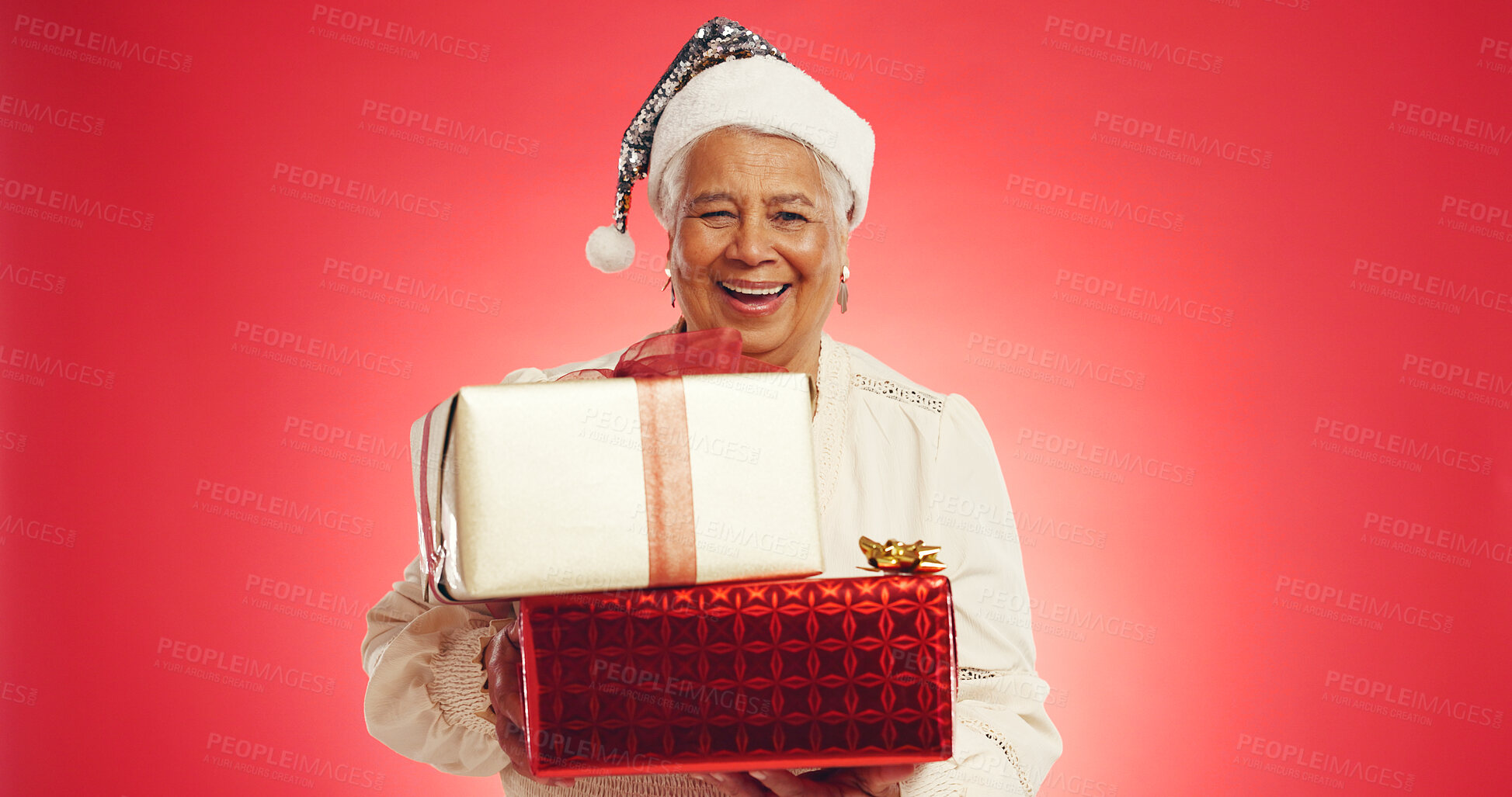 Buy stock photo Christmas, senior woman or gift in studio with portrait, happy or giveaway box in retirement. Elderly person, excited or present on red background space for festive season, Xmas tradition or surprise