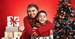 Christmas, portrait and happy kids hug with siblings for love and holiday celebration. Girl, children and embrace boy on xmas with brother, sister and family with laugh on red studio background
