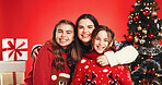 Portrait, children and happy with mom, Christmas or hug on festive event, studio or December holiday. Love, woman and bonding with kids on Xmas season, red background and decorations for tree in USA