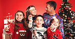 Happy, christmas and portrait of family with sparklers in studio with tradition, festive or holiday celebration. Smile, bonding and children with parents for xmas season together by red background.
