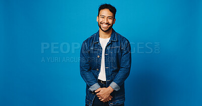 Buy stock photo Smile, fashion and portrait of man on blue background for trendy denim, casual clothes and confidence. Mockup space, studio and person with positive attitude, happy and pride in style for aesthetic