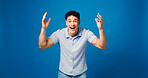 Man, smile and surprise in studio portrait with good news, announcement or winning on blue background. Person, happy and excited with wow, shock and mock up space for deal, sale or prize in Colombia