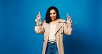 Portrait, pointing up and woman in studio, smile and announcement with offer on blue background. Model, space and happy person with hand gesture, promotion and opportunity with decision or choice