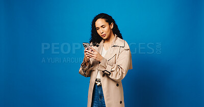 Buy stock photo Phone, confused and reading with woman in studio for phishing, fake profile and social media scam. Clickbait link, password check and mockup space with person on blue background for security update