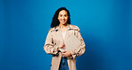 Woman, portrait and smile in studio with pride, laptop and research for story on blue background. Journalist, happy and mockup space for report, article or draft for business newsletter or website