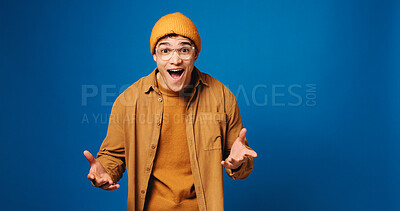 Buy stock photo Happy man, surprise and portrait with reaction to news in studio, announcement or expression on blue background. Mockup space, wow or shock with male person, alert or mindblown with notification