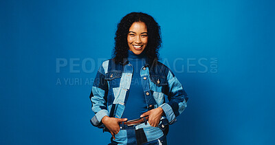 Buy stock photo Happy, fashion and portrait of woman on blue background for trendy style, casual clothes and confidence. Mockup space, studio and person with positive attitude, smile and pride in denim for aesthetic