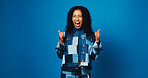 Excited, woman and thumbs up for success with winner, goal or fashion sale on blue studio background. Happy, model and like hand gesture for victory, celebration or trendy promo with mockup space