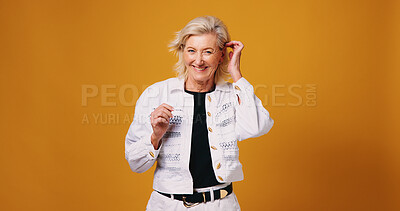 Buy stock photo Smile, startup and portrait of mature woman in studio for fashion designer, entrepreneur or pride. Stylist, about us and trendy with person on orange background for creative director on mockup space