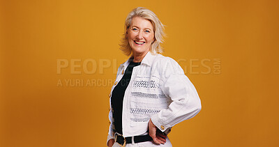 Buy stock photo Smile, pride and portrait of mature woman in studio for fashion designer, entrepreneur or startup. Stylist, about us and trendy with person on orange background for creative director on mockup space