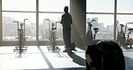 Back, fitness and man thinking by gym window for reflection, wellness or view with stationary bike. Black person, health club and thoughts with exercise bicycle, workout planning or training decision