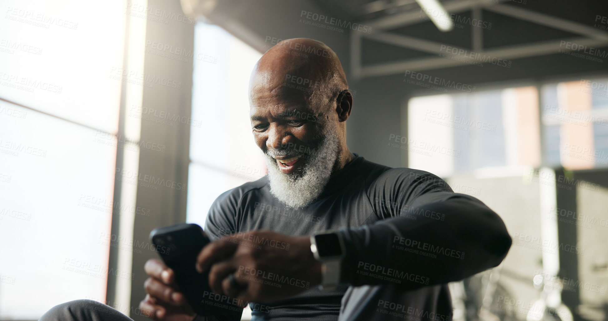 Buy stock photo Man, laughing and athlete with smartphone, gym or watching fitness video on social media or website. Happy, online and black person with mobile app for entertainment, funny post and break with tech
