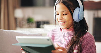 Buy stock photo Tablet, headphones and happy child on sofa online for watching videos, educational games and internet. Relax, weekend and girl on digital tech for subscription, streaming movies and elearning in home