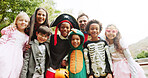 Halloween, outdoor and portrait with parents, kids and celebration with happiness, tradition and smile. Group, friends and children in backyard, costume party and fun with fantasy, trick and treat 