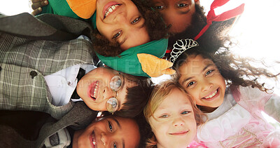 Buy stock photo Below, portrait and children with costumes outdoor for Halloween party, celebration and bonding. Huddle, kids and smile with character outfits for spooky season, cosplay holiday and friends together