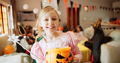 Buy stock photo Bucket, halloween and portrait of happy girl child in living room of home for celebration of holiday. Candy, costume and smile of excited kid fairy in apartment for Autumn tradition of trick or treat