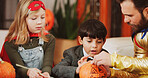 Halloween, help and father with kids, decoration and holiday with fun, drawing and family party. Bonding together, home and dad with children, learning and creative art with celebration and pumpkin