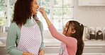 Mother, child and baking with flour on nose, laughing and bonding together with family in kitchen. Cooking, kid and mom in home with funny game, learning and parent play with daughter for love