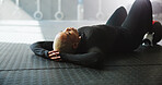 Breathing, woman and break on floor in gym, calm and complete workout in morning, resting and peace. Relax, athlete or wellness for African person in health club, stress relief and done with exercise