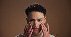 Moisturizer, skincare and portrait of man in studio for beauty, natural or facial glow. Cosmetic, face cream and male person from Canada with lotion for dermatology routine by brown background.