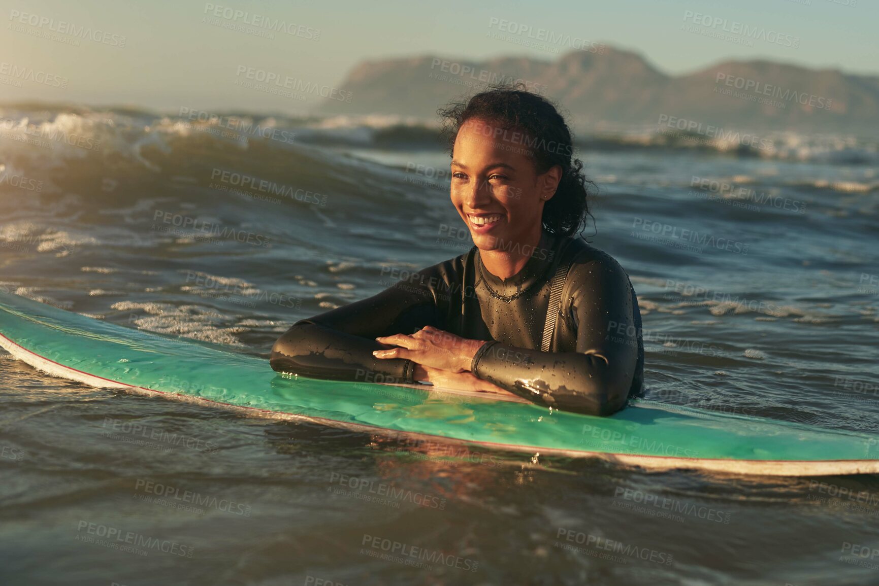 Buy stock photo Surfboard, woman and swimming in ocean with wetsuit for summer adventure, sunset and fun hobby for waves. Girl, surfing sport and floating in water with board for vacation travel, relax and wellness