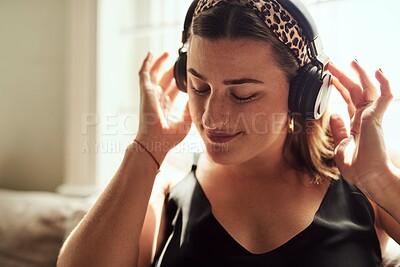 Buy stock photo Relax, music and woman with headphones, lounge and chilling with radio, streaming and comfortable. Home, sound and calm on couch, listening and person in living room, podcast and rest in apartment