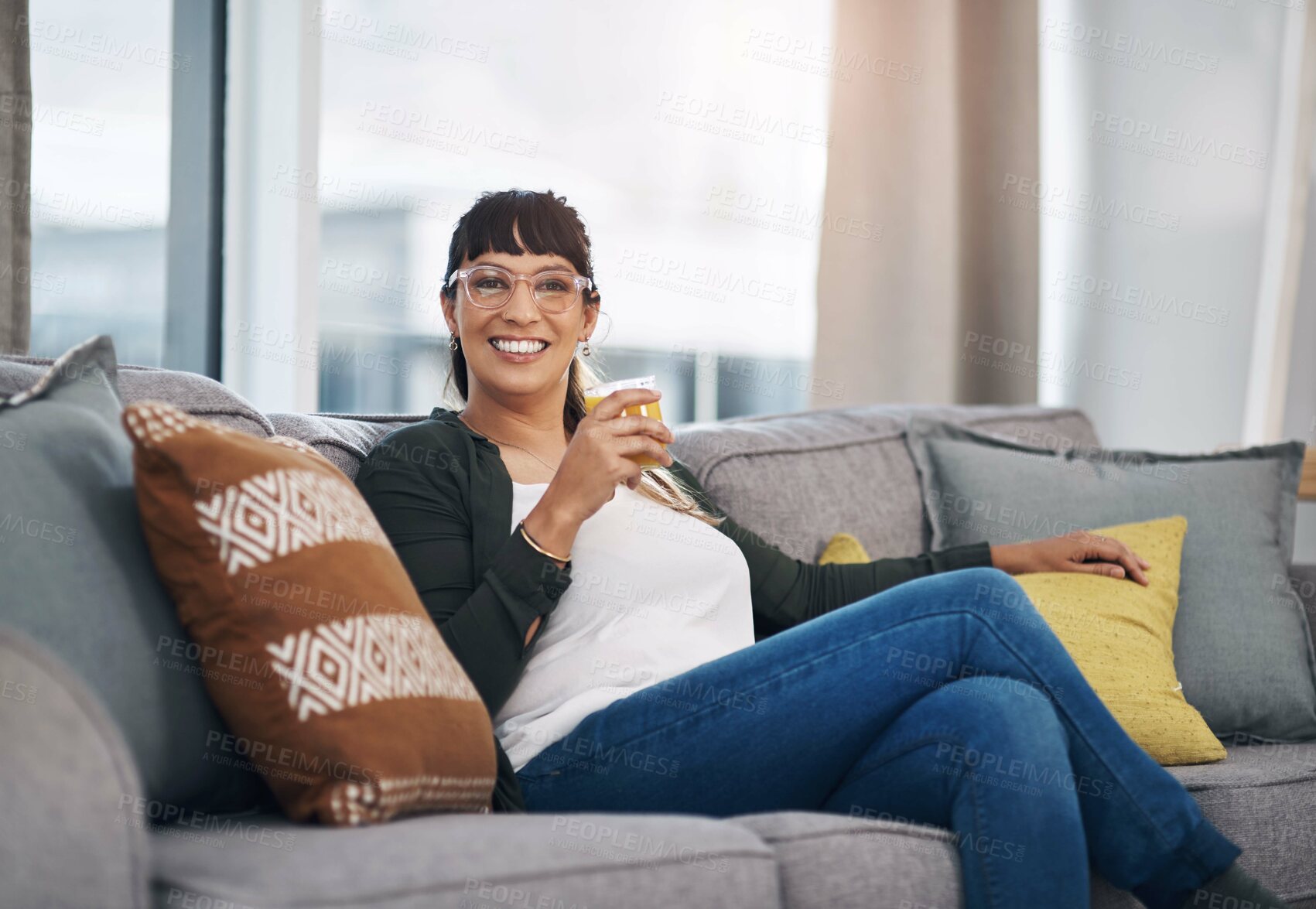 Buy stock photo Woman, juice and smile in portrait on sofa with drink for breakfast, health or diet in home living room. Person, fruit punch or happy for nutrition, detox or glass to lose weight at house in Colombia
