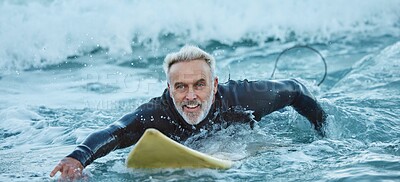 Buy stock photo Surf, sea and sports with a mature man surfer in the water for sport, fitness and surfing during summer. Training, workout and exercise with a male athlete on his surfboard in the ocean alone