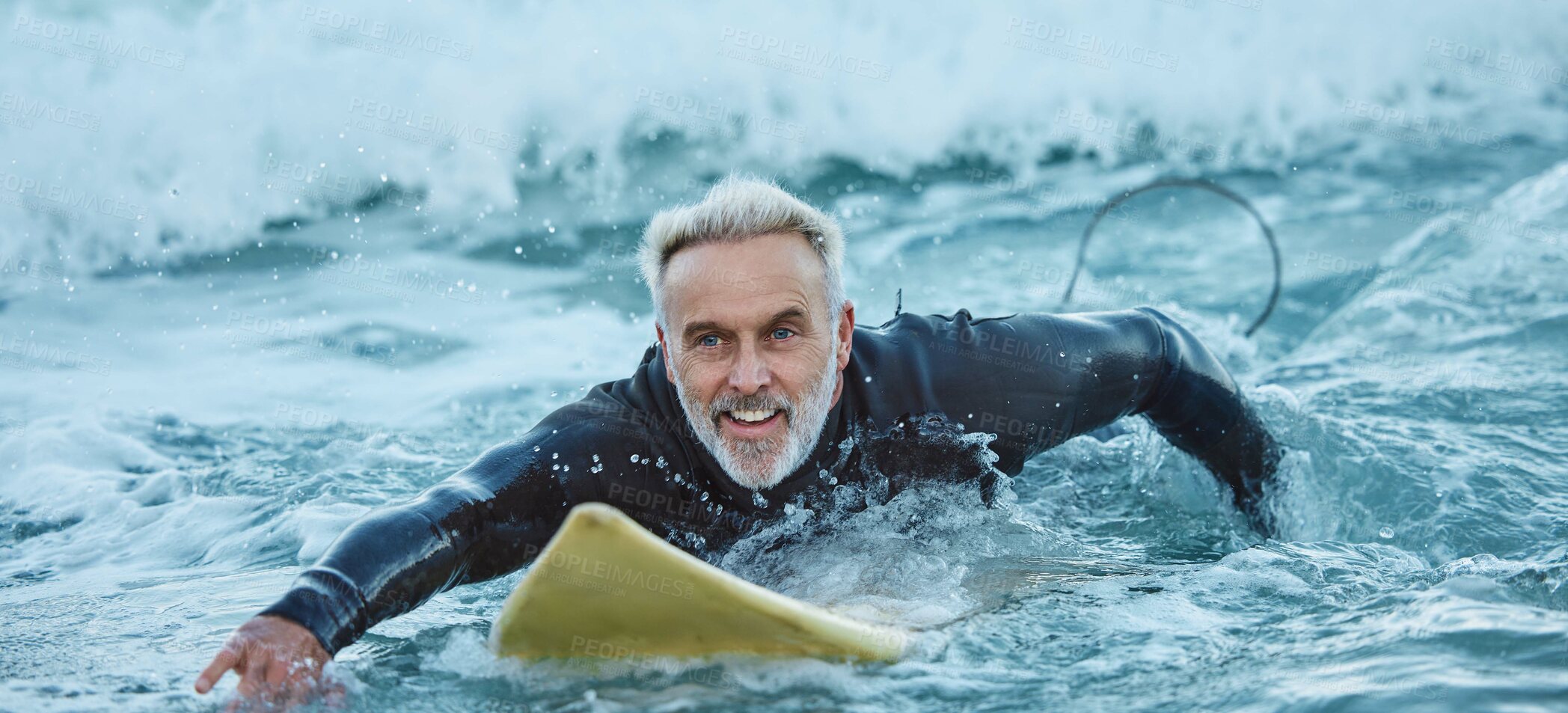 Buy stock photo Surf, sea and sports with a mature man surfer in the water for sport, fitness and surfing during summer. Training, workout and exercise with a male athlete on his surfboard in the ocean alone
