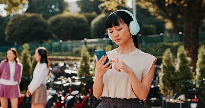 Buy stock photo Headphones, phone and college with Japanese woman in park for streaming, University campus and online playlist. Music, radio and education podcast with person and mobile in Japan outdoor for student