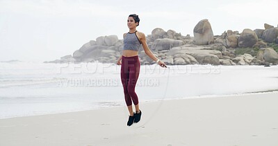 Buy stock photo Beach, exercise and skipping with sports woman outdoor for cardio training or workout in morning. Fitness, jump rope and view of horizon with athlete person at ocean or sea for health challenge