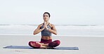 Woman, meditation and namaste at beach, peace and mindfulness with space for breathing exercise. Person, eyes closed and yoga on ground with mat, nature and outdoor by ocean on vacation in Australia