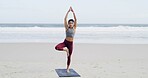 Woman, yoga and tree pose at beach with balance, mindfulness and breathing exercise in nature. Person, meditation and zen with stretching, ocean and wellness routine for awareness with in New Zealand