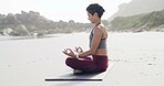Lotus pose, meditation and woman on beach with peace, mindfulness and zen for breathing. Namaste, balance and female person with yoga for wellness, health and exercise with calm on mat by ocean.