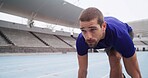 Athlete, man and ready to start on track for cardio workout, marathon training and race at stadium. Runner, set and running take off for competition fitness, endurance exercise and sports performance