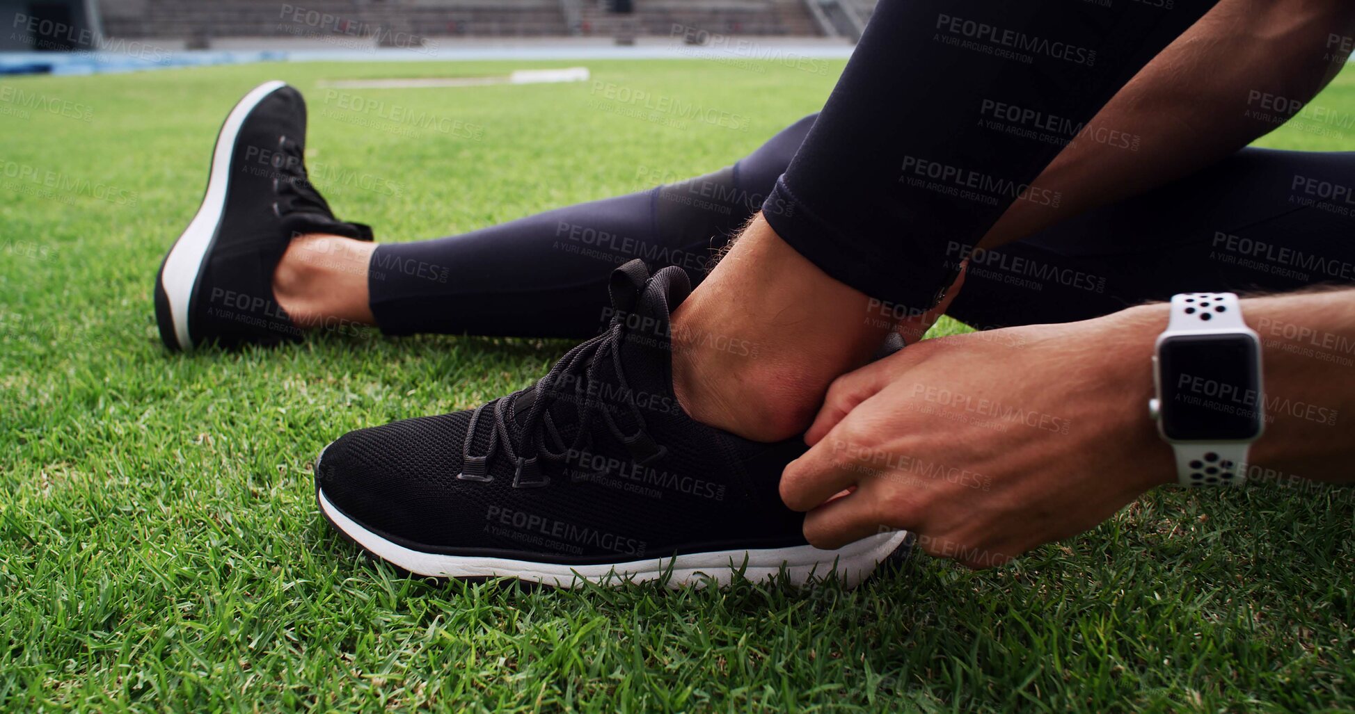 Buy stock photo Fitness, hands and shoes with person on grass in stadium for start of competition or tournament. Exercise, getting ready and sneakers with athlete or runner outdoor on field for sports event closeup