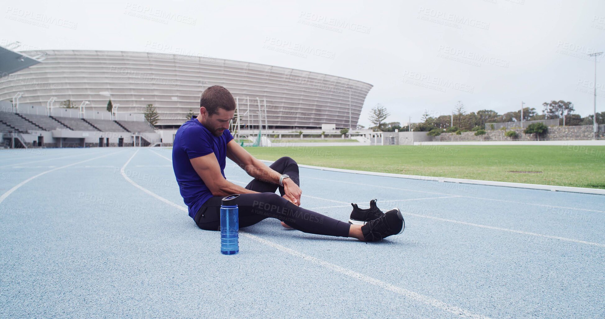 Buy stock photo Fitness, foot pain and man in stadium for accident, emergency or physical risk with training. Exercise, injury and massage with athlete or runner on track at venue for fatigue or muscle cramp