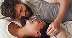 Love, relax and couple with laughing on bed for funny conversation, bonding together and support. Home, people and happy with affection in bedroom for relationship joke, marriage security and trust