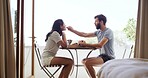Breakfast, feeding and romance with couple on balcony of home together for bonding or love. Eating, hunger and morning with happy people outdoor at apartment for anniversary, connection or honeymoon