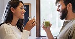 Happy couple, smoothie and glass for wellness in kitchen, care and bonding for nutrition at apartment. Woman, man and smile with green drink, benefits and healthy diet with detox for profile at house