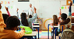Teacher, students and arms raised in classroom with kids for education, question or answer for knowledge. Man, children with why or learning for academic growth, future and educator teaching in class