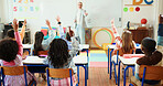 Teacher, students and arms raised in classroom with children for education, question or answer for knowledge. Man, kids with why or learning for academic growth, future and educator teaching in class
