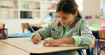 Buy stock photo Girl, paper and writing test in classroom with problem solving, development or assessment at academy. Child, answer and solution for question with mathematics, learning and quiz at elementary school