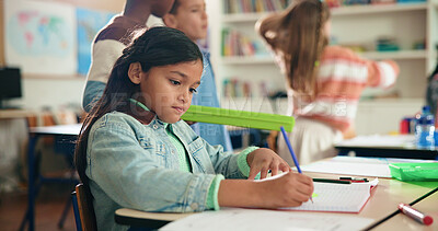 Buy stock photo Girl, writing and book for learning in classroom, development or notes for assessment at academy. Child, paper and thinking with solution, problem solving and task for education at elementary school