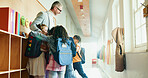 Hug, children and teacher at school for welcome, education development and support. Encourage, greeting or group of happy kids with man for learning, students and fun in morning in academy hallway