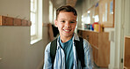 Portrait, child and smile with backpack at school for education, learning and scholarship. Happy, kid and student in hallway for study opportunity, knowledge growth and academic pride in preschool