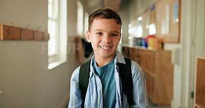 Buy stock photo Portrait, child and smile with backpack at school for education, learning and scholarship. Happy, kid and student in hallway for study opportunity, knowledge growth and academic pride in preschool