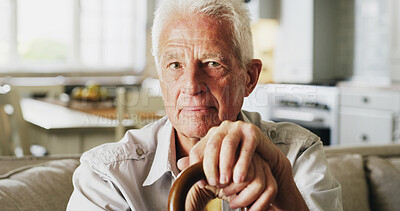 Buy stock photo Serious, walking stick and portrait of senior man in home with relax, peace and medical support. Retirement, mobility aid and elderly person with disability, parkinson or arthritis on sofa in house.