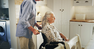 Buy stock photo Morning, relax and wheelchair with old couple in kitchen of home together for support or wellness. Love, retirement and senior man pushing woman with disability in apartment for assistance or help